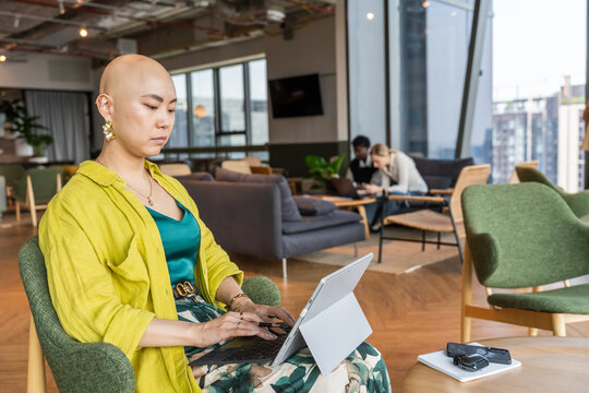 Businesswoman Working on a Tablet in a Modern Workspace During the Day