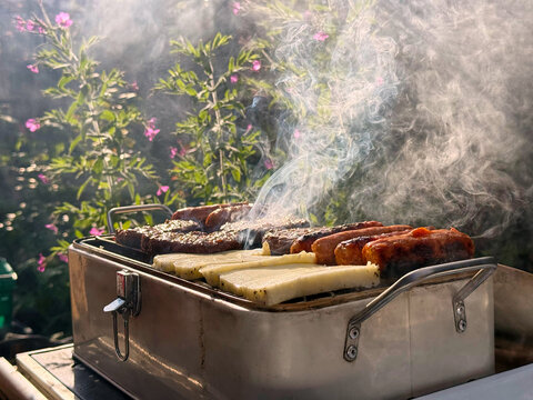 Smoke Rising From Garden Barbecue On Sunny Day