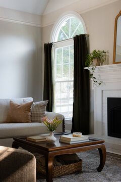 Sunlit Living Room with White Fireplace and Vaulted Ceiling