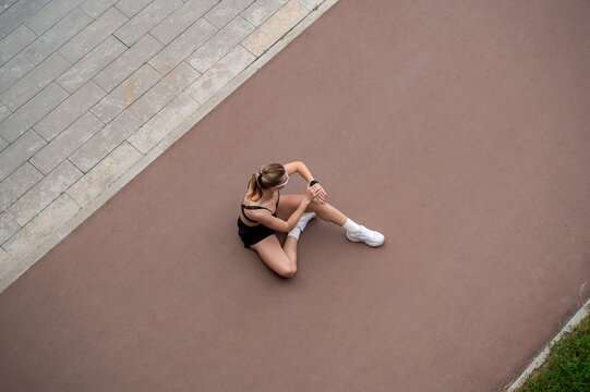 Athletic woman resting after cardio workout outdoors