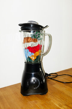Conceptual image of blender filled with colourful glitter fabrics