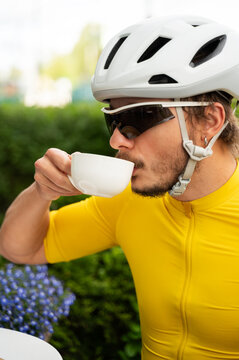 Stylish urban cyclist drinking coffee during a training break