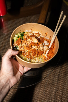 Holding Takeout Rice Bowl at Home
