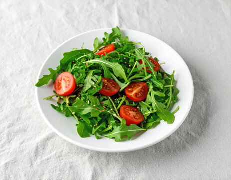 Arugula and cherry tomato salad in white bowl