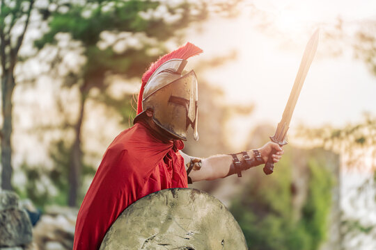 Spartan Warrior in Bronze Helmet with Sword and Shield Ready for Battle