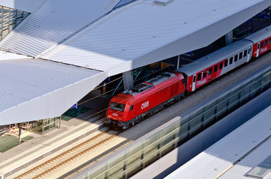 view onto a red city shuttle train of the austrian federal railway at the new Viennese main train station, Austria