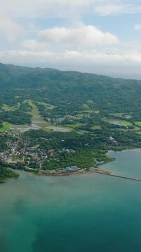 Looc Poblacion with residential area and agricultural land. Tablas Island. Romblon, Philippines. Vertical view.