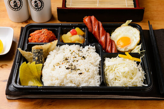 Korean lunch box dosirak with rice sausage and side dishes