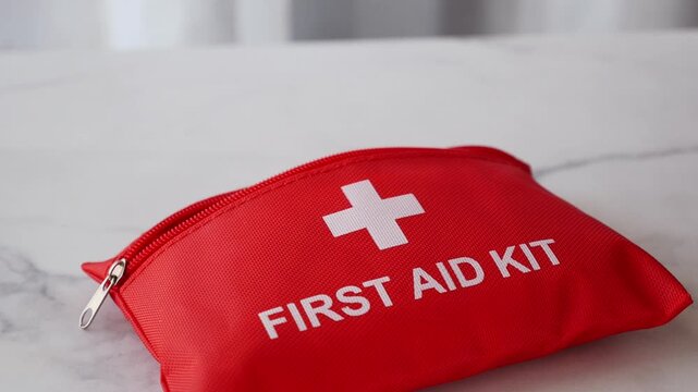 Close up of woman taking medication from first aid kit for emergency care.