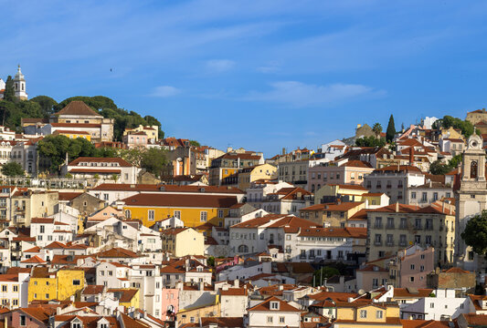 Panoramic Lisbon skyline of the old historic center with traditional orange tile roofs and colorful buildings