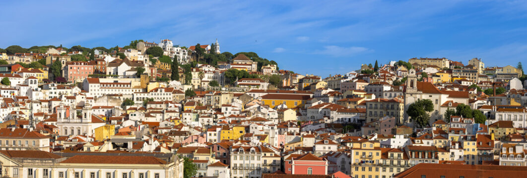 Panoramic Lisbon skyline of the old historic center with traditional orange tile roofs and colorful buildings