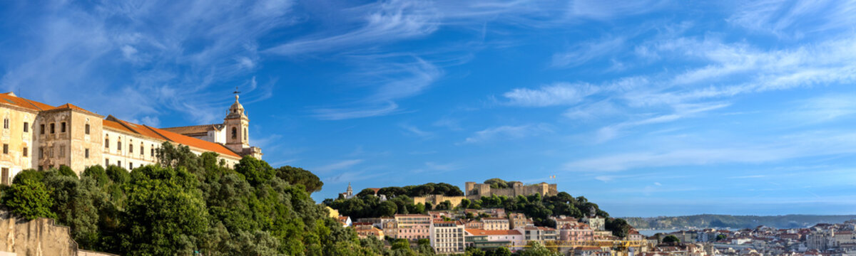 Panoramic Lisbon skyline of the old historic center with traditional orange tile roofs and colorful buildings
