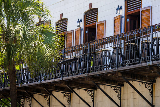 Tropical balcony with wooden shutters and bar stools in Key West Florida in historic center