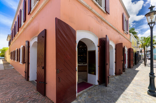 Historic colonial building with red wooden shutters on a street in Charlotte Amalie, Saint Thomas US Virgin Islands