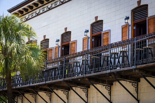 Tropical balcony with wooden shutters and bar stools in Key West Florida in historic center