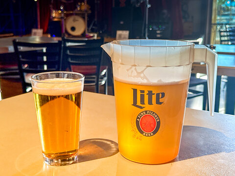 Las Vegas, Nevada, USA - 3 July 2026: Jug of Miller light pilsner lager beer on a table in a bar with a full glass of beer.