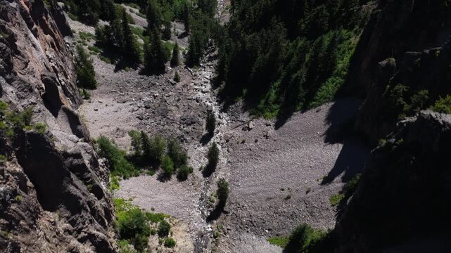 Aerial of North Fork Clear Creek canyon river gorge in Wenatchee National Forest with steep forested cliffs in central Washington