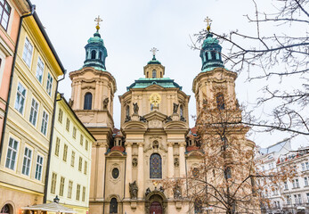 Fototapeta premium Low angle view of the Baroque St. Nicholas Church facade in the Old Town Square, a UNESCO World Heritage site in Prague.