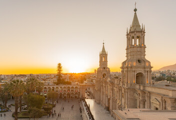 Obraz premium Sunrise over the Basilica Cathedral of Arequipa and Plaza de Armas in Arequipa, Peru, with warm golden light illuminating the historic heart of the White City