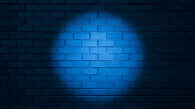 Dark blue brick wall texture illuminated by a single circular spotlight creating a dramatic contrast and atmospheric lighting effect in a room
