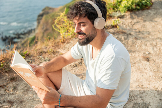 Remote worker relaxing reading book digital detox outdoors