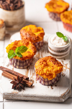 Sweet homemade cottage cheese muffins with pumpkin on white background