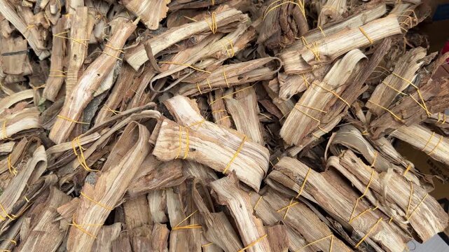 Dried walnut tree bark bundles traditionally used as dandasa chew sticks for natural Muslim oral hygiene and teeth cleaning.