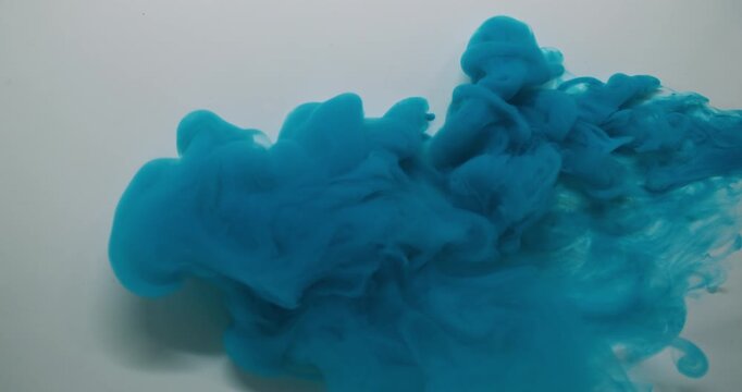 Paint steam. Dye spread. Blue puff spray cloud flow spiral spill liquid pigment white background. Abstract blur color fog explosion.