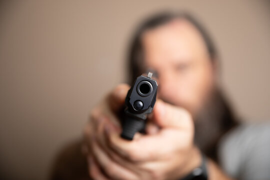 Handgun aims straight ahead