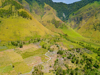 Fototapeta premium Aerial drone view of lush greenery hills near Toba Lake at Silalahi in Desa Binangara, Samosir, Sumatra Utara, Indonesia