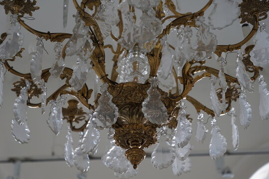 Elegant vintage crystal chandelier with intricate gold metal details