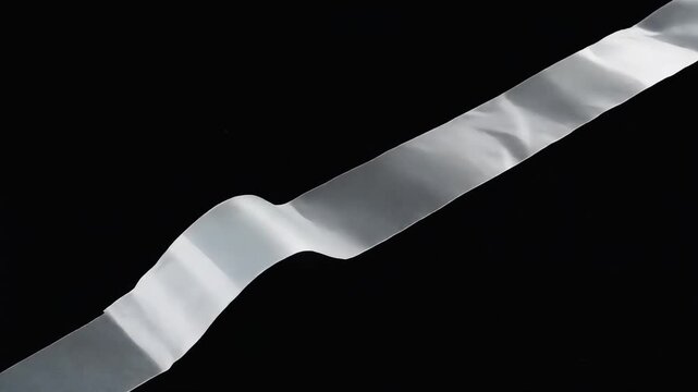 Translucent satin sash on black background