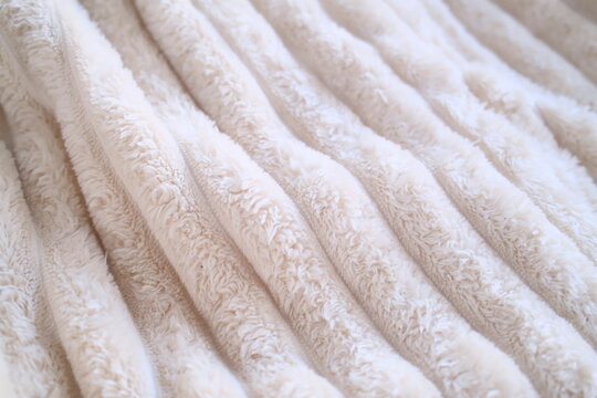 Soft, plush white folds ripple gracefully, creating a warm, peaceful sanctuary in the gentle morning light of home.