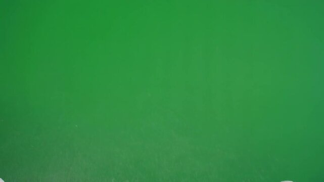 Drifting snowflakes rising upward in reverse gravity effect. Winter motion background with floating ice particles on green screen.