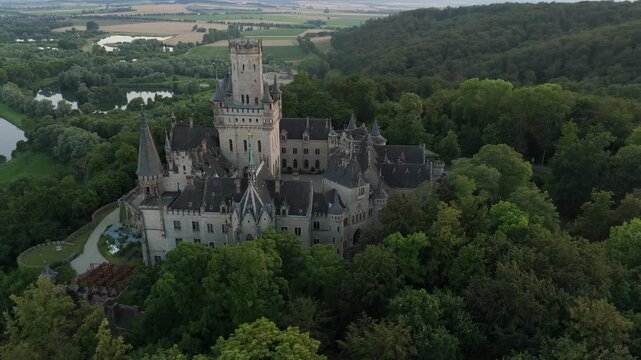Marienburg Castle above forest with the Leine river beyond