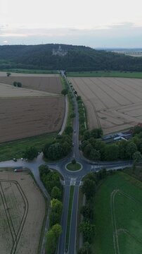 Vertical video of a country roundabout and fields in rural Germany