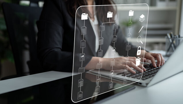 Business Professional Working on Laptop with Digital File Management Interface for Productivity and Organization in Modern Office Environment. Sentient.