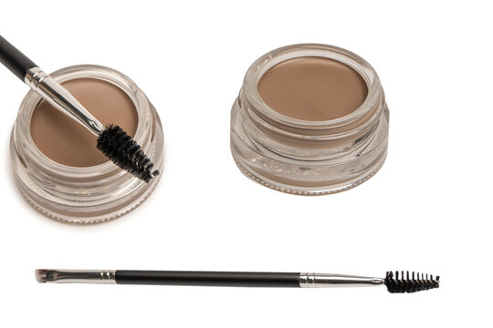 A brow pomade in blonde shade with brush isolated on a white background.
