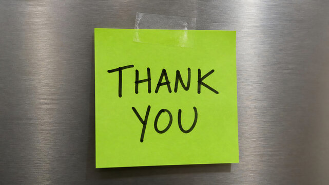 A neon green sticky note with the words "THANK YOU" written in black marker is taped to a brushed metal surface.