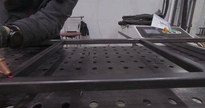 A skilled worker welds metal beams. Metal structures specialist.