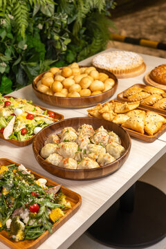Festive Central Asian food table with manti dumplings baursaks and fresh salads