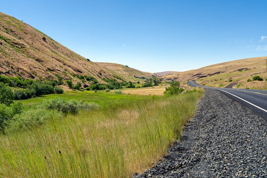 Willow Creek Road curves between the rolling hills of northeastern Oregon, United States