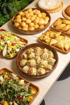 Traditional central asian feast table with manti dumplings baursak and samsa pastries