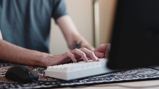 Focused Typing Session. Engaged In Concentrated Writing With Keyboard And Mouse In Personal Workspace. Media