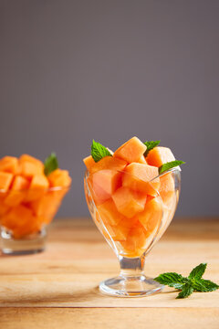 Freshly cut melon pieces in a glass bowl
