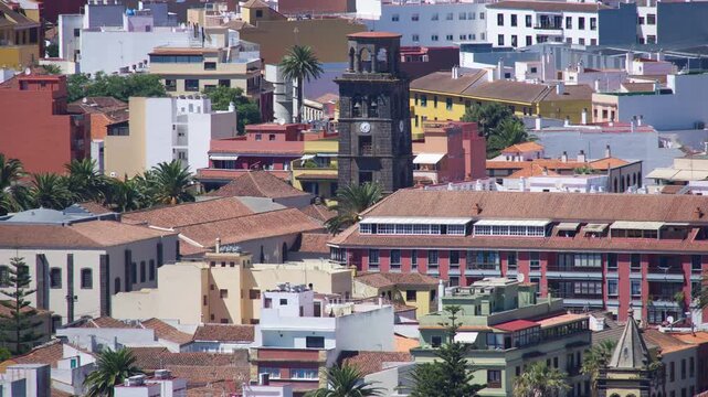 This cityscape shows the historic center of San Crist&oacute;bal de La Laguna on Tenerife, Spain. The striking, dark bell tower in the center belongs to the Iglesia de Nuestra Se&ntilde;ora de la Concepci&oacute;n.