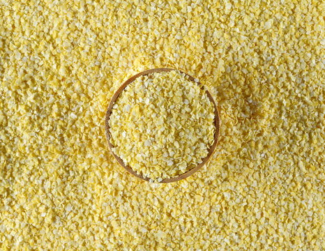Corn flakes pile in bamboo bowl background