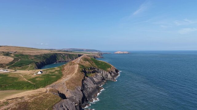 Aerial view of a coastal campsite on rugged cliffs in Wales, UK