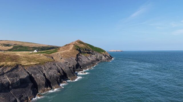Aerial view of a coastal campsite on rugged cliffs in Wales, UK