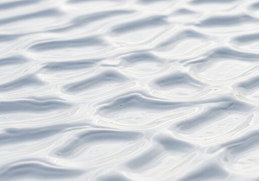 A close-up view of creamy white mud with thick ripples and smooth textures creating an organic pattern across the entire damp surface area, raw, creamy, matte